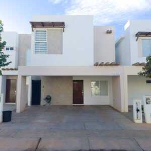 Exterior de casa en venta con acabados de piedra natural, cochera para dos autos y diseño arquitectónico moderno en Almarena 1314.